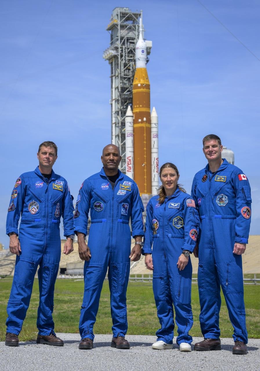 NASA astronauts Reid Wiseman, Artemis II commander, left, Victor Glover, Artemis II pilot, Christina Koch, Artemis II mission specialist, and CSA (Canadian Space Agency) astronaut Jeremy Hansen, Artemis II mission specialist, right, stop for a group photograph as they visit NASA’s Artemis II SLS (Space Launch System) rocket and Orion spacecraft, Monday, March 30, 2026, at Launch Complex 39B of NASA’s Kennedy Space Center in Florida. Photo Credit: (NASA/Bill Ingalls)
