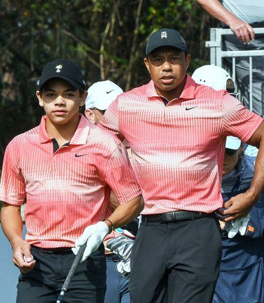 Tiger Woods and his son Charlie Woods wait to tee off on the first hole during the first round of the 2022 PNC Championship at The Ritz-Carlton Golf Club in Orlando. PNC Championship Golf Tournament in Orlando, US - 17 Dec 2022